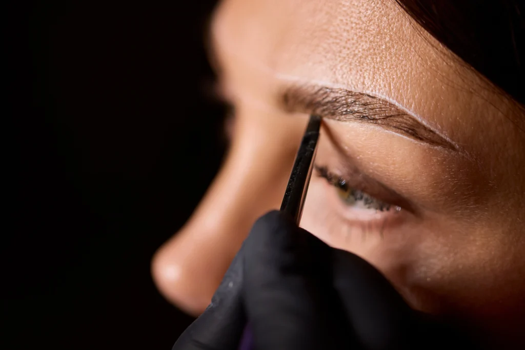 Close-up of eyebrow tinting process